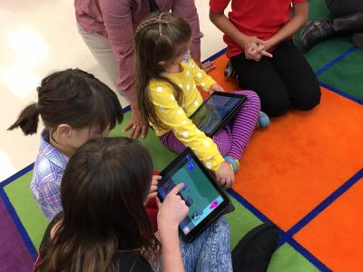 photo of students coding together using ipads