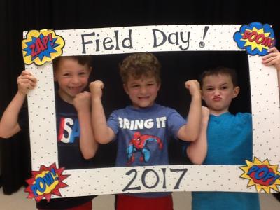 photo of students holding field day photo booth frame