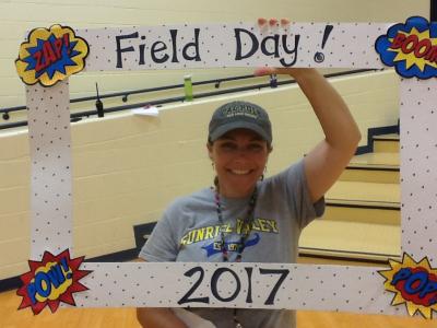 photo of teacher holding field day photo booth frame